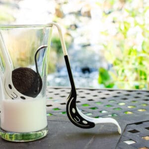 A glass of milk and cookie on the table