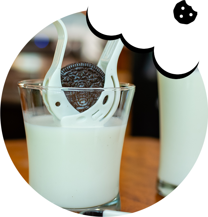 A glass of milk with cookies in it