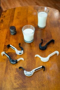 A wooden table with milk and cookies on it