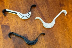 Three different types of hooks on a wooden table.