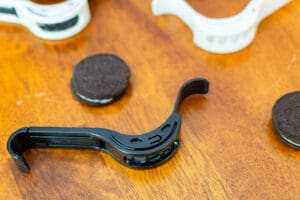 A close up of an oreo cookie on top of a guitar