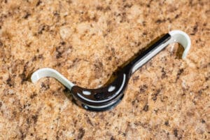 A black and white bottle opener on the floor