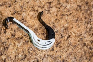 A pair of black and white forks on the ground.